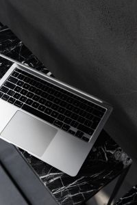 Kaboompics - Macbook Pro laptop - marble - decorative plaster on wall - black aesthetics
