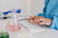 Female scientist - computer keyboard - work - desk