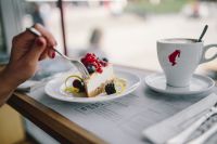 Kaboompics - Woman Enjoying Cheese Cake and a Coffee with Fruits in a Cafeteria