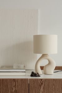 Ceramic lamp styled on a commode with a stone top