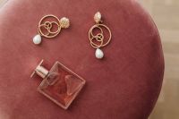 Kaboompics - Jewellery & pink perfume on Pouf
