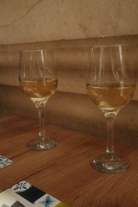 Kaboompics - Two Glasses of White Wine on a Rustic Wooden Table With a Mediterranean Touch