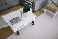 Kaboompics - Small wooden table with a potted plant and a grey wallet