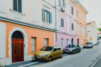 Kaboompics - Colourful tenement houses in Izola, Slovenia. Cars parked on the street.