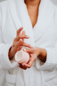 A middle-aged woman applying hand cream