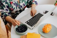 Kaboompics - Woman, MacBook laptop, blueberries, kiwano fruit
