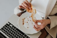 Businesswoman eats a croissant - food