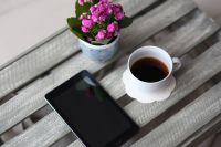 Little pink flowers with a coffee and a smartphone