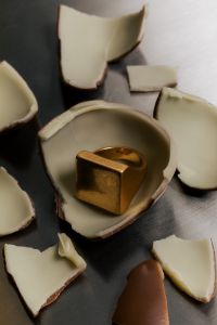 Kaboompics - Golden Statement Ring Nestled in Chocolate Shell