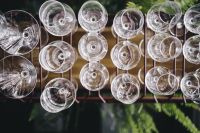 Kaboompics - A big bunch of wine glasses hanging from a holder