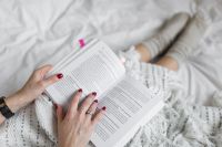 Kaboompics - Soft photo of woman on the bed with the book
