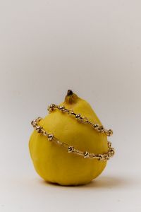 Kaboompics - Golden Chain Highlighting the Unique Texture of a Quince