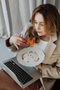 Businesswoman eats a croissant - food