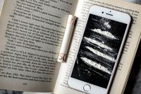 Kaboompics - Cocaine on a smartphone iPhone, opened book