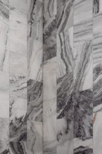 A detailed look at a marble-textured wall with unique veining patterns in grey and white tones