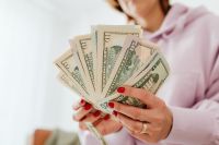 Kaboompics - Woman counts money - dollars - currency - bill