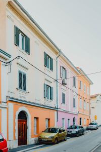 Kaboompics - Colourful tenement houses in Izola, Slovenia. Cars parked on the street.