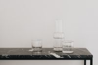 Kaboompics - Water in a transparent glass carafe and glasses on a black marble console