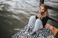 Kaboompics - Blonde woman having a healthy snack at the wooden pier