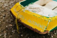 Kaboompics - Little yellow green boat on the beach