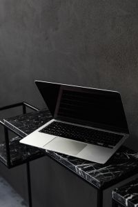Macbook Pro laptop - marble - decorative plaster on wall - black aesthetics