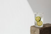 Tall glass with water - lime - ice cubes