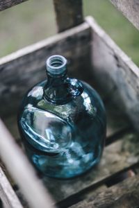 Cyan decorational bottle in a wooden crate