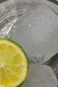 Glass with water - lime - ice cubes - closeup - close-up - close up