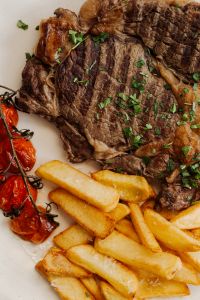 Kaboompics - Gourmet Plate with Steak - Fries - Dip - Grilled Tomatoes