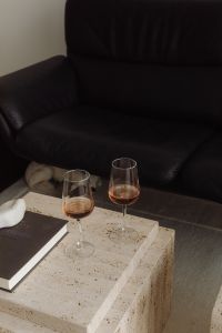 Kaboompics - Two glasses of rose wine on a travertine table