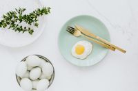 Kaboompics - Easter flat lay with green eggs and fried egg on a plate