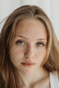 Young Beautiful Woman with Blue Eyes - Natural Sensitive Skin with Imperfections