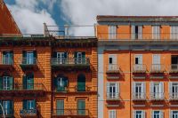 The facade of an orange tenement house in Naples