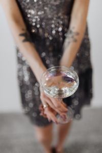 Woman in a Sequin Dress is Holding a Glass of Champagne, White Background