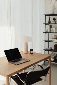 Wooden table - laptop - candle - shelves - travertine lamp