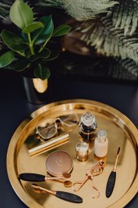Makeup essentials on a golden tray