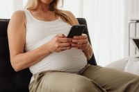 Pregnant Woman Working on Laptop at Home