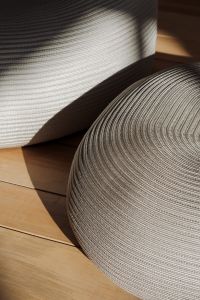 Softly Lit Patterned Poufs on Wooden Floor