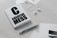 Kaboompics - Top view of black and white typography sentences, copy space, earphones, pen