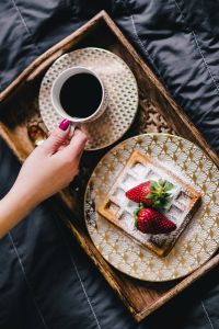 Saffle with strawberries and cup of coffee