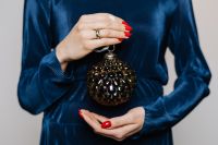 Kaboompics - Woman in Blue Blouse Holds a Christmas Tree Bauble