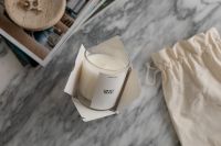 Kaboompics - Elegant Aromatic Candle Unboxing on Marble Tabletop - UGC Style Interior Design