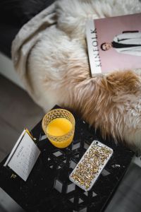 Kaboompics - Bedside table, iPhone mobile, Kinfolk magazine and cup of orange juice