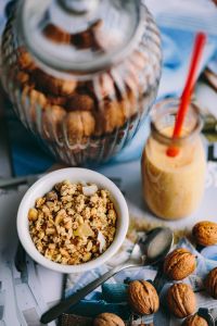 Kaboompics - Jar full of walnuts with a fresh healthy shake and musli in a bowl