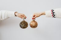 Hand Holding Christmas Tree Baubles