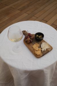 Kaboompics - Elegant Cheese and Grape Platter with a Glass of White Wine