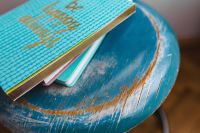 Blue notebooks on a blue wooden stool