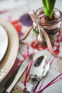 Utensils and a small plant on an easter table