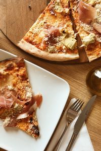 Pizza with Prosciutto on the white plate