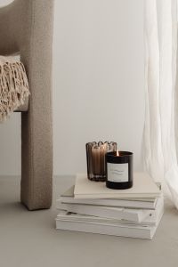 Home decorations - beige armchair - candles - book - blanket